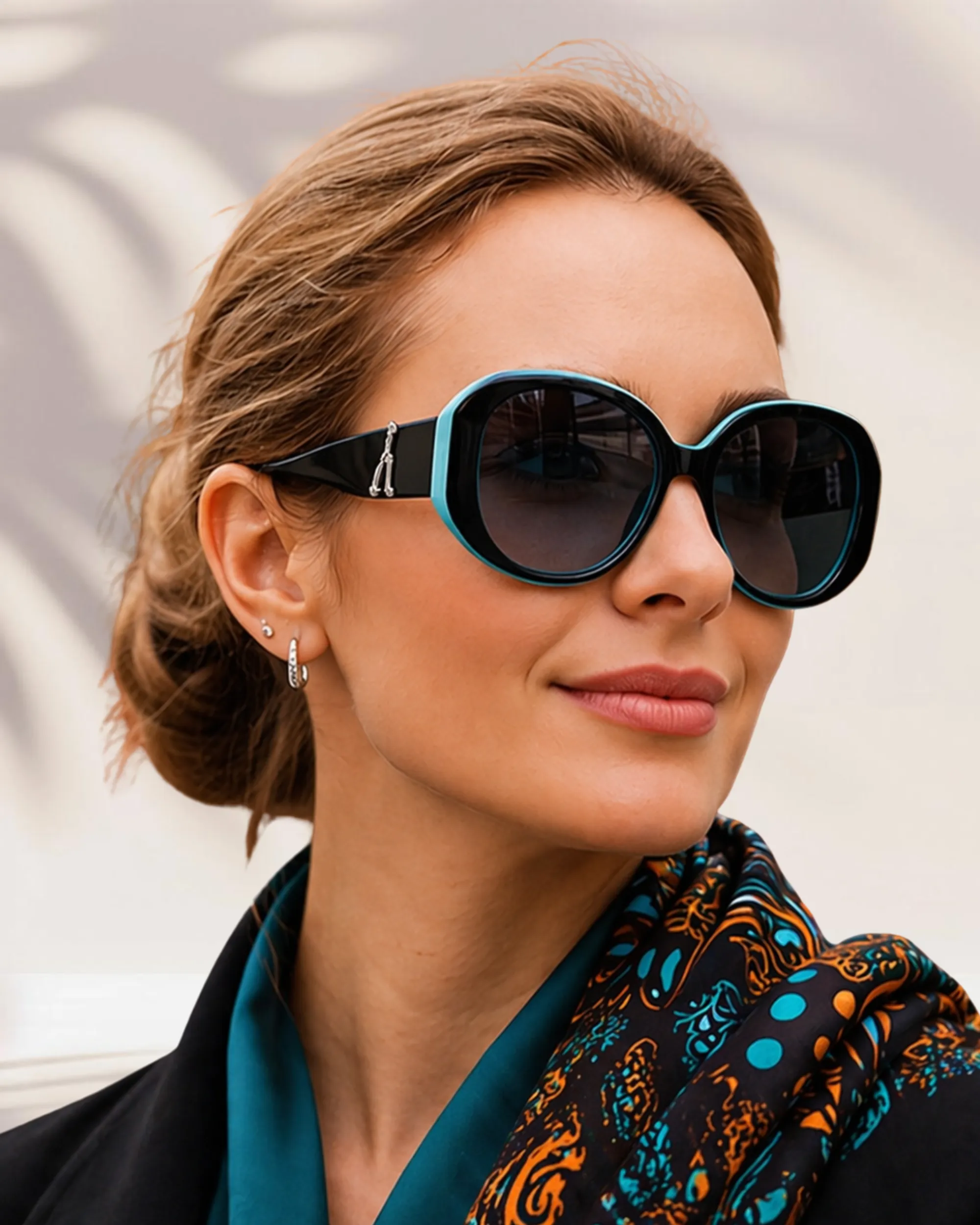 Black & Turquoise Polarized Sunglasses Woman wearing black and turquoise polarized sunglasses with oversized round frames and dark tinted lenses