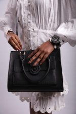 Model wearing DUAFE gunmetal black boyfriend watch with interchangeable bezels