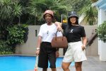 Model Wearing Black bucket hat with white Zuri Nzuri print