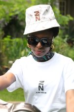 Model wearing Sublimated bucket hat with all-over Zuri Nzuri print in toffee tones