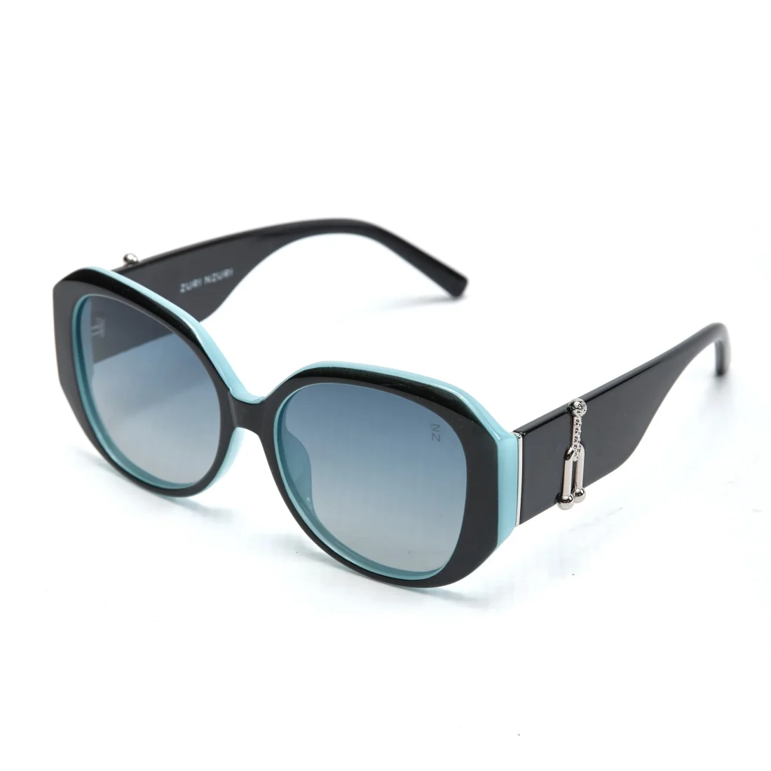 Angled view of black and turquoise polarized sunglasses with oversized rectangular frames and gradient tinted lenses