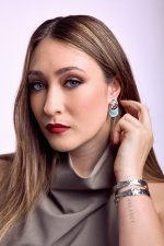Model wearing Sankofa soft blue drop earrings with rhodium plated finish
