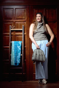 Model wearing the Sankofa soft grey city backpack styled for an urban day look