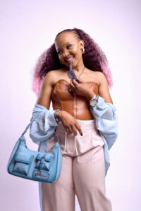 Model styled with the Fafanto slate blue shoulder bag in a relaxed contemporary outfit