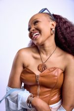 Model wearing Aban rhodium sculptural hoop earrings with fluid textured design